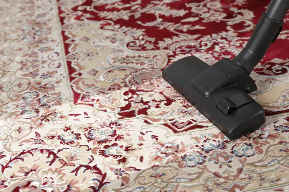 Red and white patterned rug receiving gentle professional rug cleaning